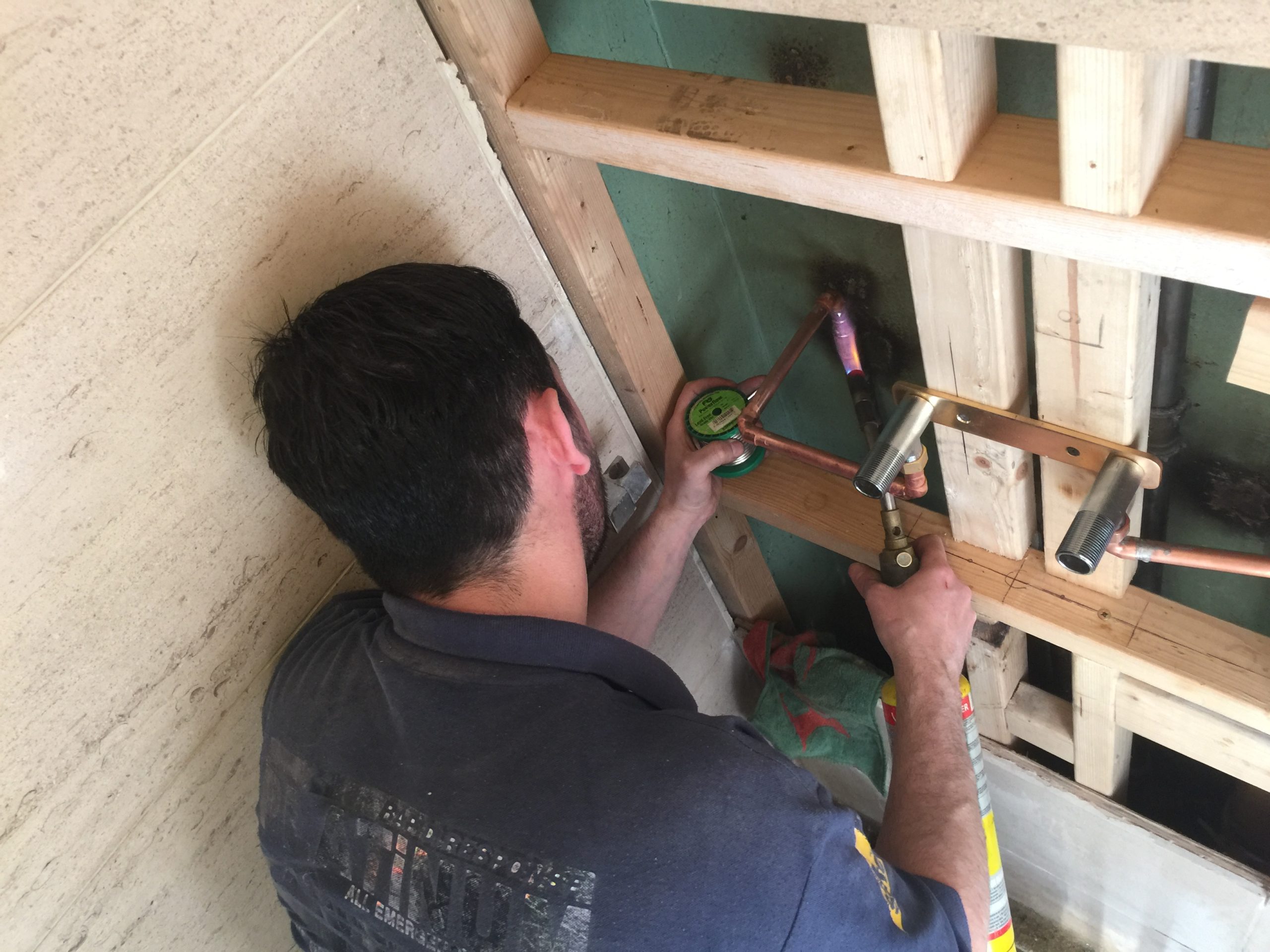 Plumber soldering pipework