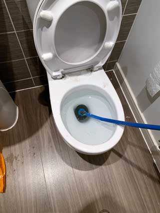 An Emergency Plumbing Unblocking A Toilet