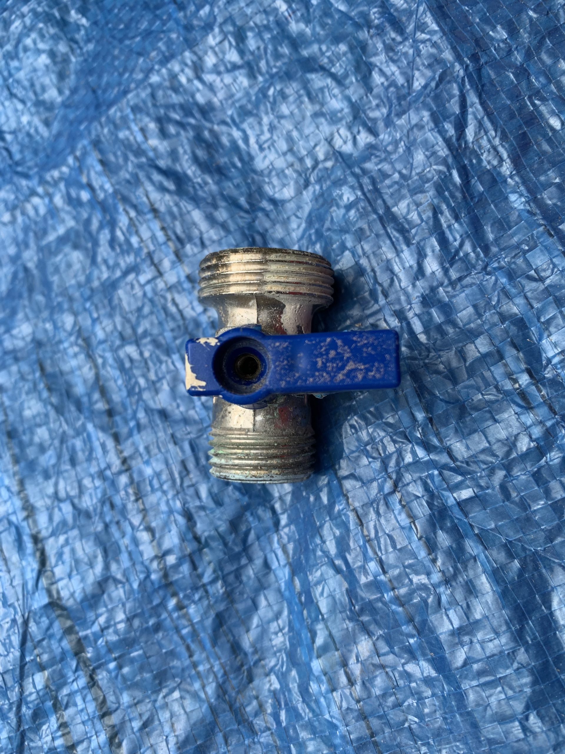 Photo showing turn style isolation valve with a blue knob.